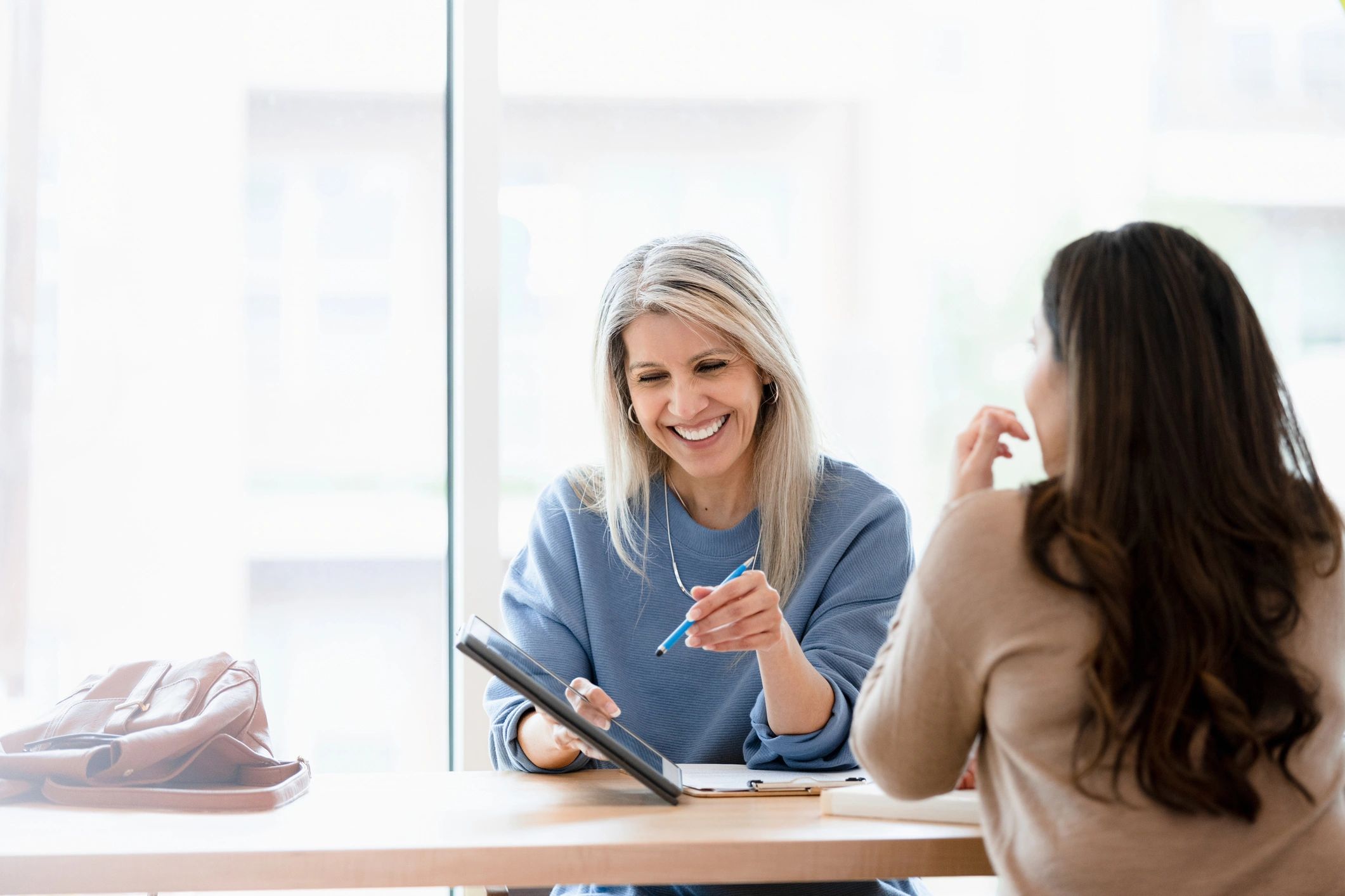 Professional client consultation reviewing business documents