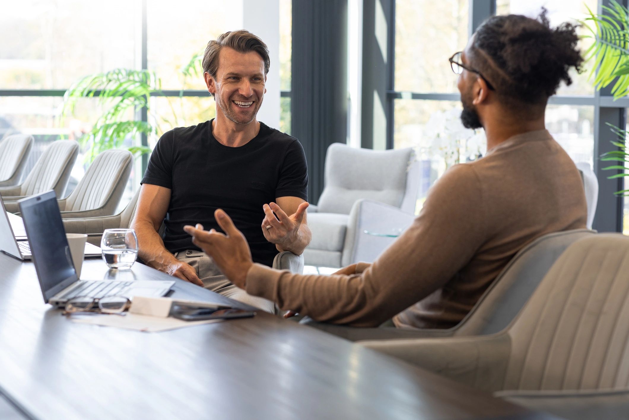 Two professionals discussing strategy in a conference room